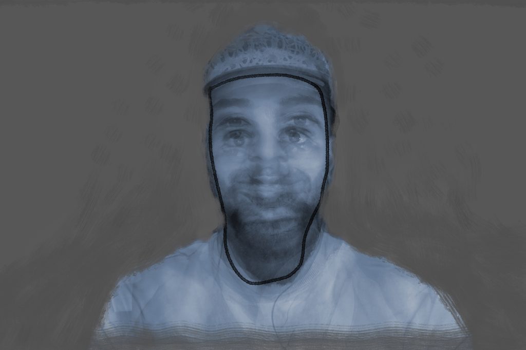 A blue-toned portrait of a man staring forward, expression unreadable, against a neutral background.
