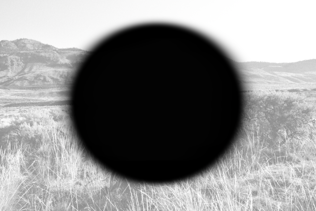 black circle on grayscale mountain landscape background